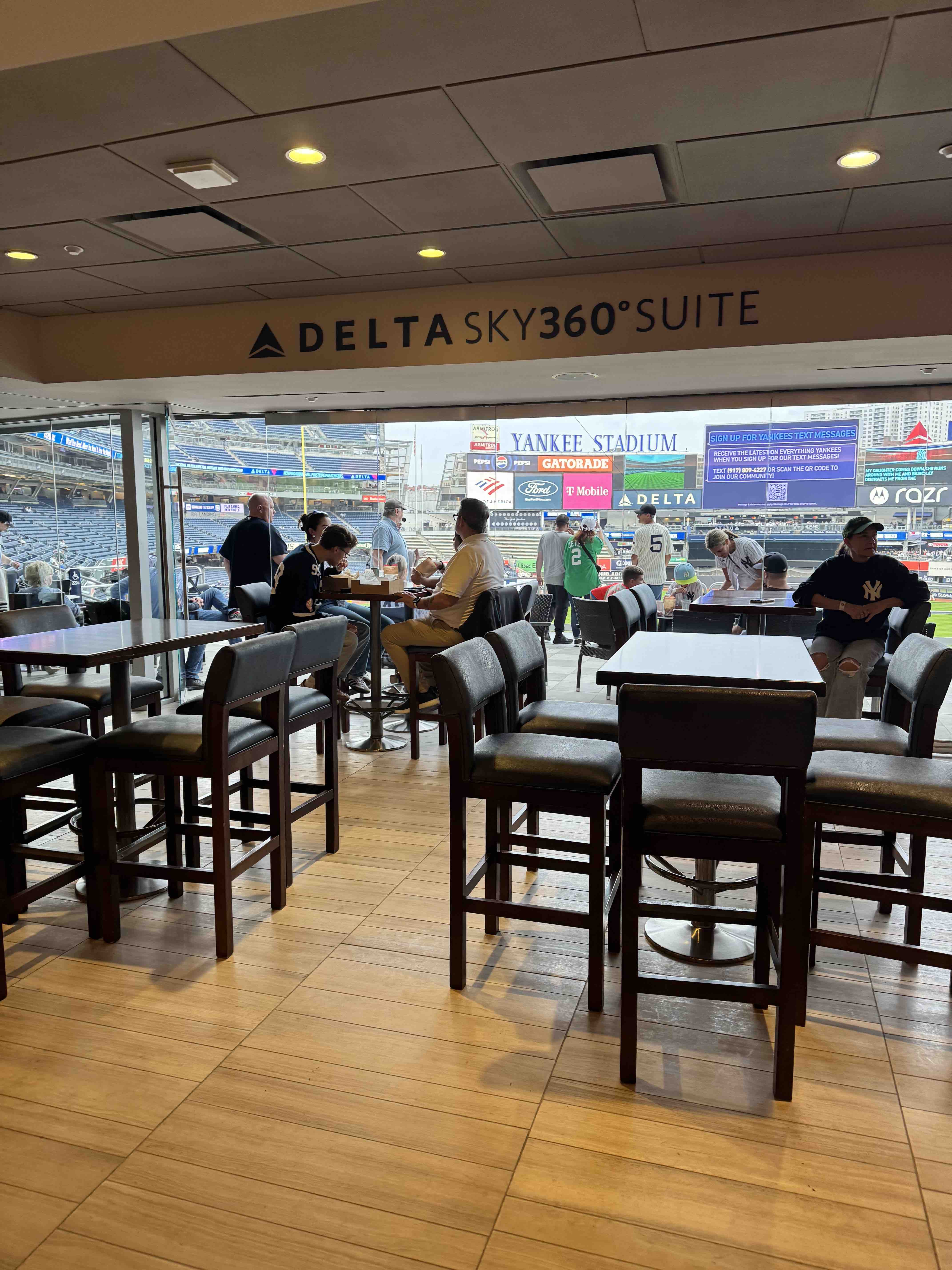 Delta SKY360° Club premium seating area at Yankee Stadium with lounge seating and field views.